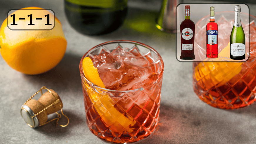 Negroni Sbagliato glass on table close to orange and prosecco bottle - brigzen