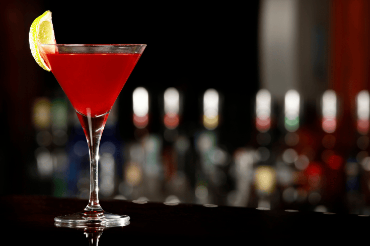 elegant cosmopolitan drink with lemon decoration - brigzen